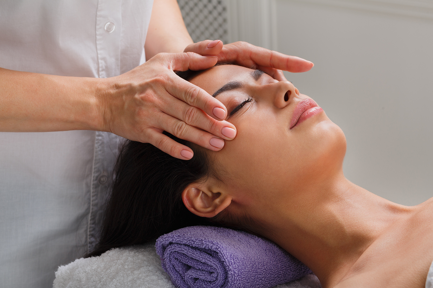Woman receiving facial massage for facelift