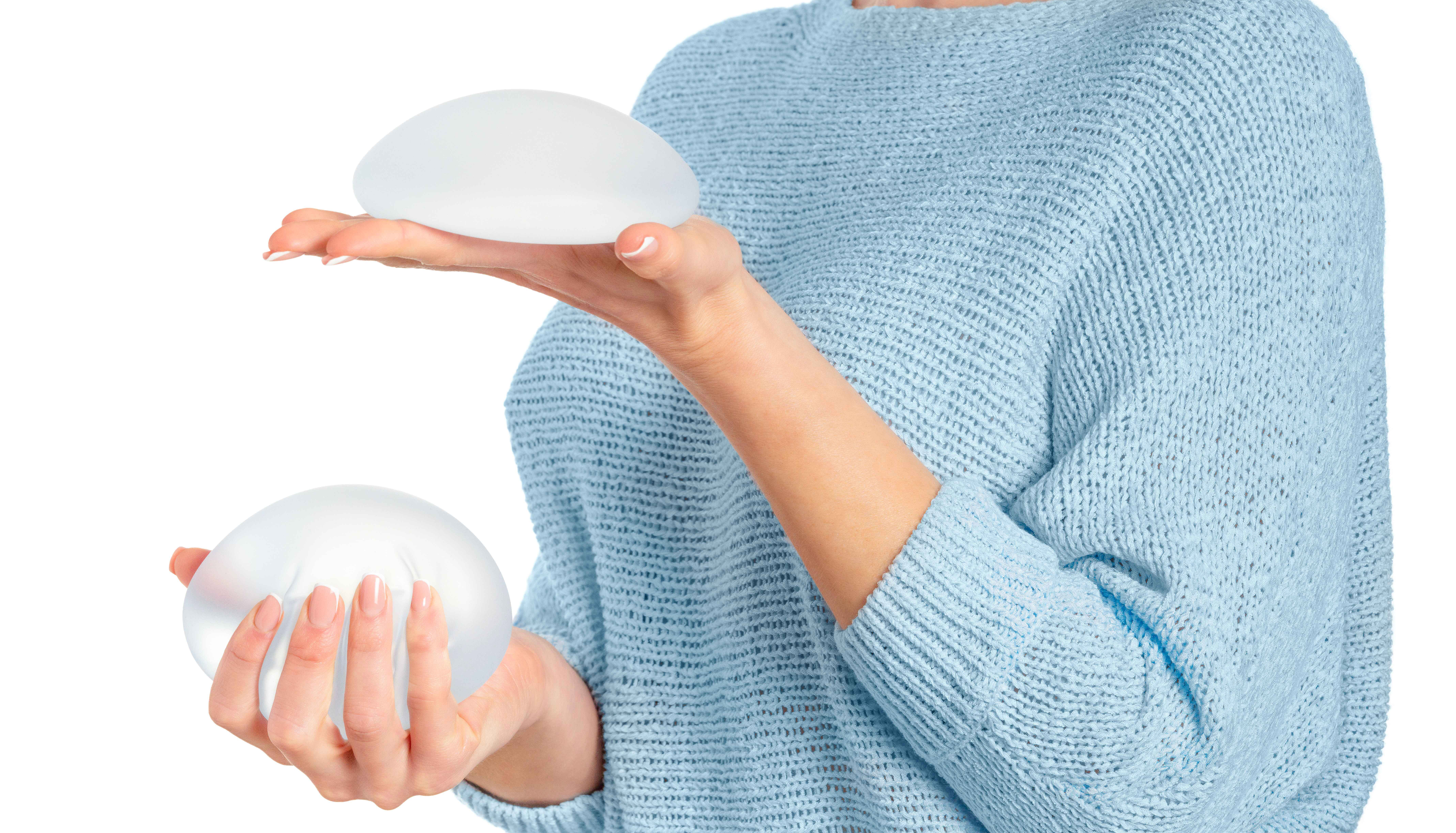 woman holding breast implant silicone